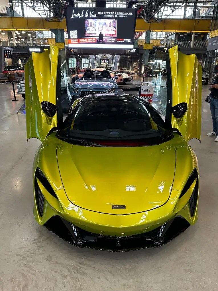 McLaren Artura Spider 2024, rear view — Veyra Cars, Europe. The McLaren Artura Spider pairs a folding hard-top with the low, wide stance the marque…